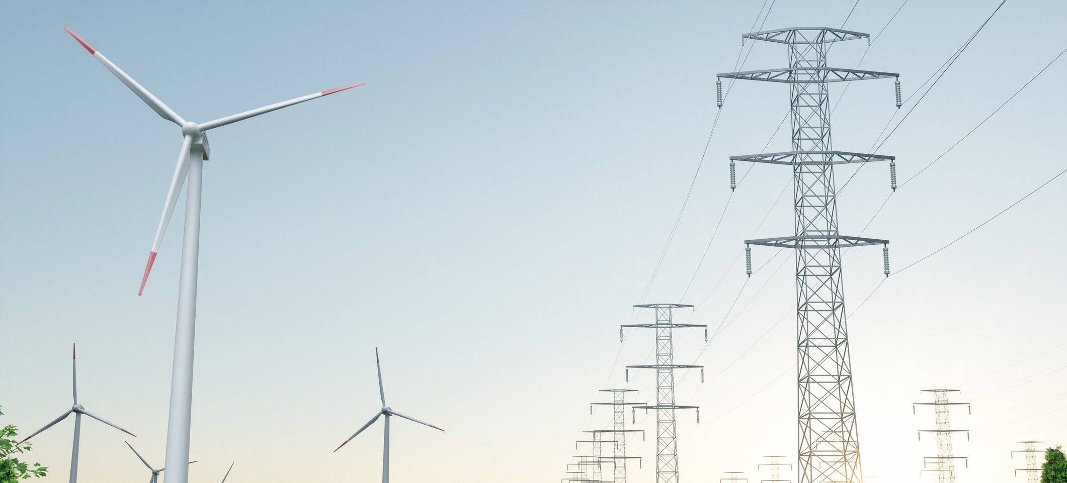 Wind turbines and electrical towers stand against a clear sky, representing renewable energy transition and infrastructure in a serene, rural landscape.