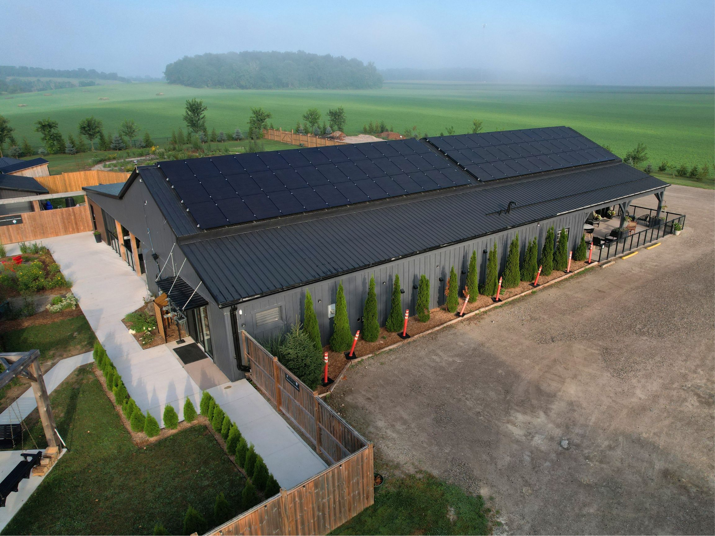 Full roof view of Terra Nova Spa & Cafe with commercial solar panels installed.