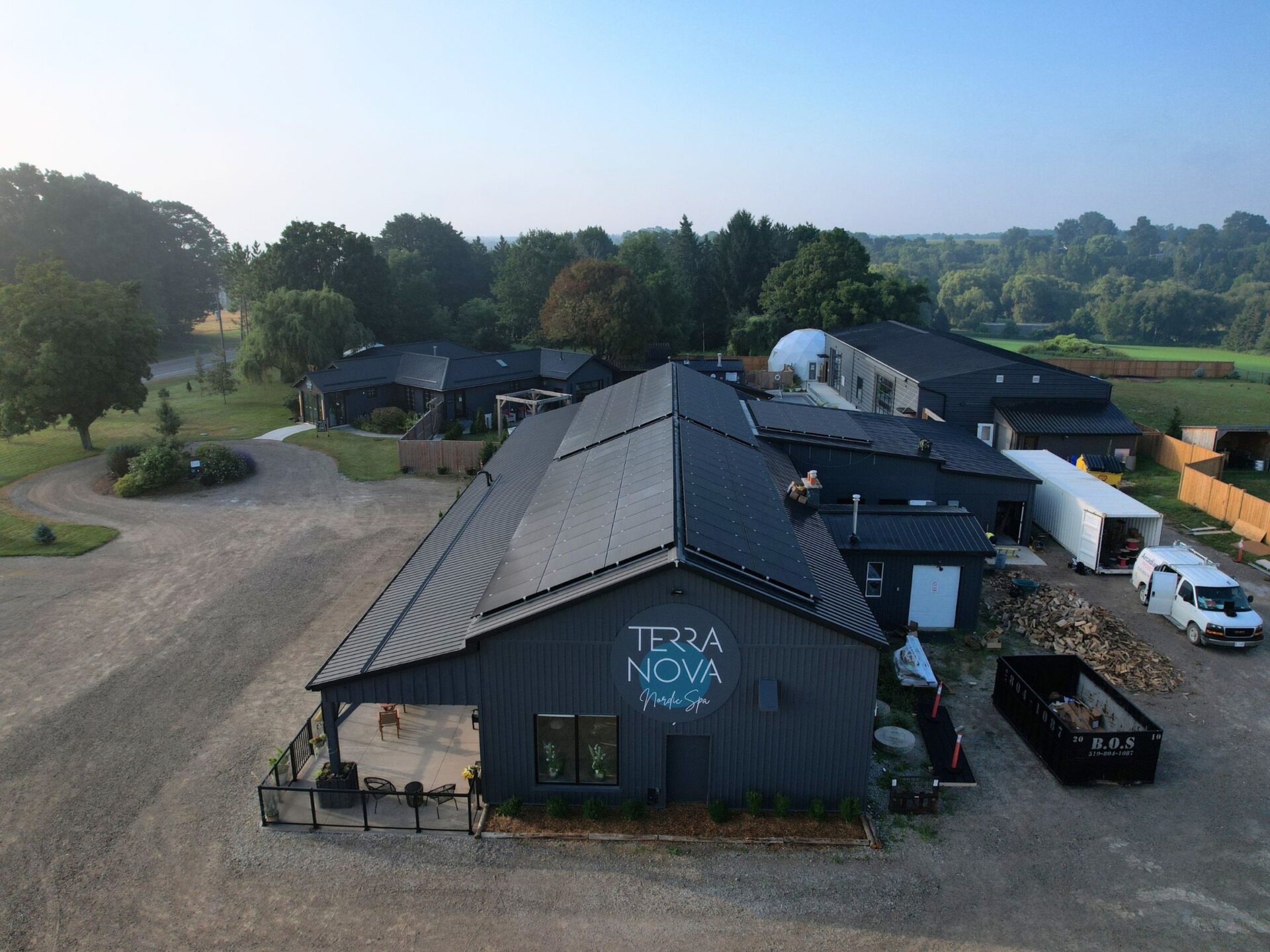 Front view of Terra Nova’ Spa & Cafe's building with commercial solar panels on the roof.