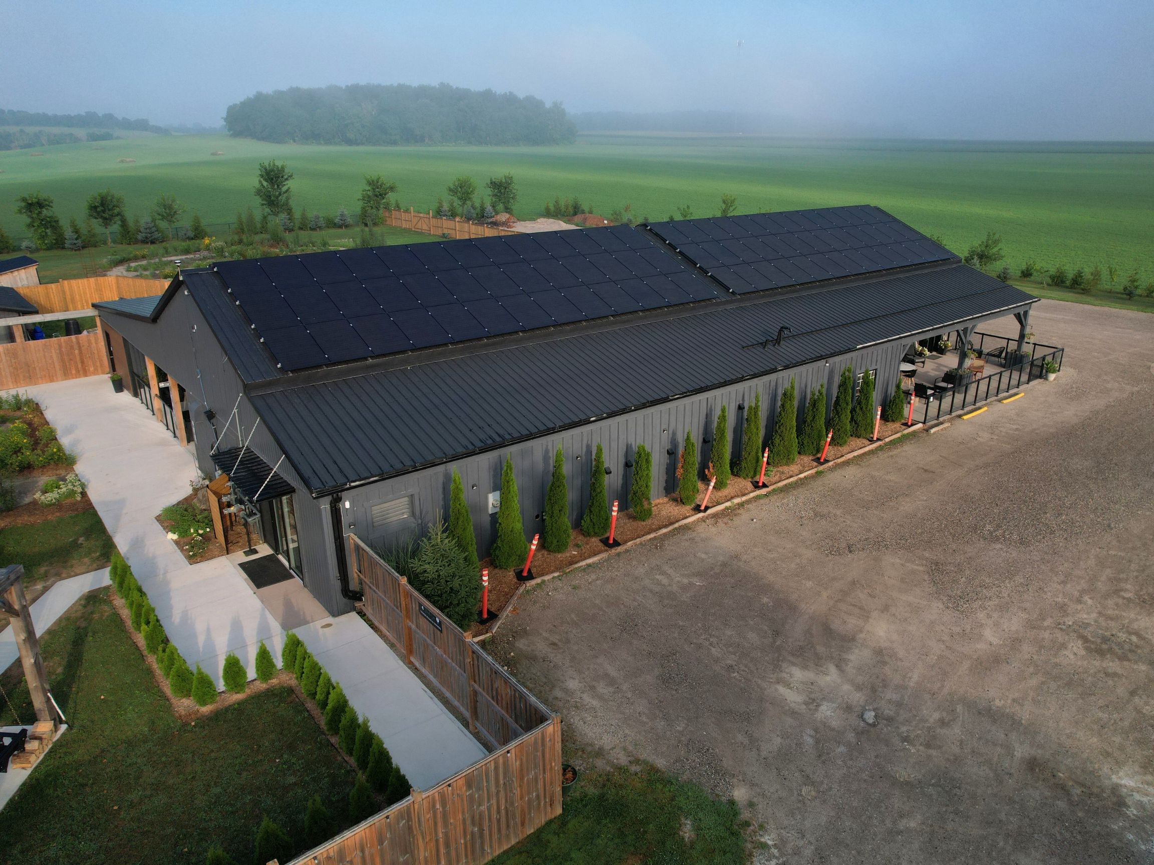 Full roof view of Terra Nova Spa & Cafe with commercial solar panels installed.